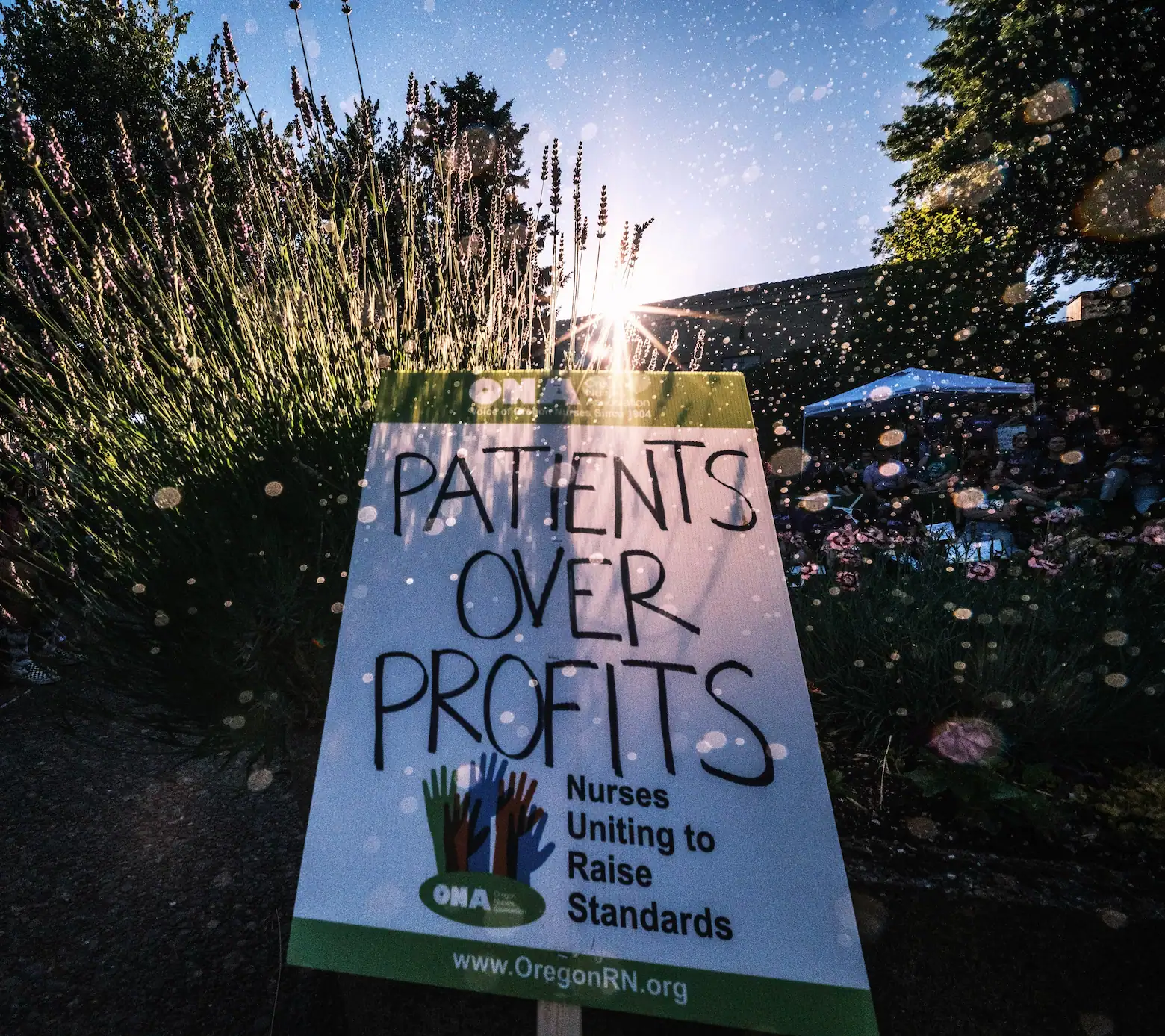 photo of a sign that says patients over profits and has the ona logo